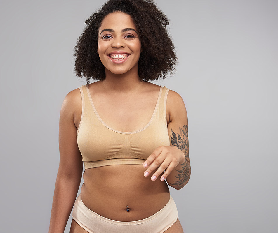 African american woman smiling wearing a bra and underwear