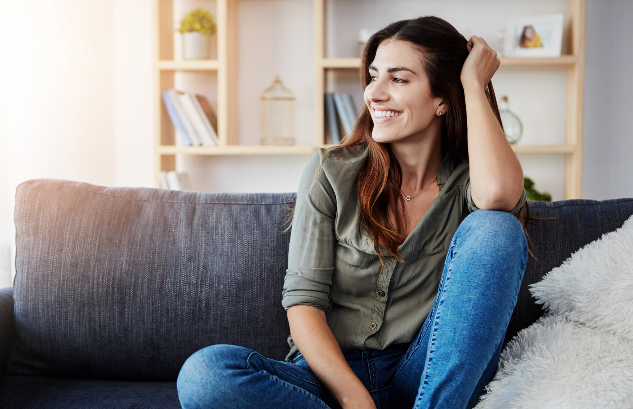 Woman smiling sitting on the couch